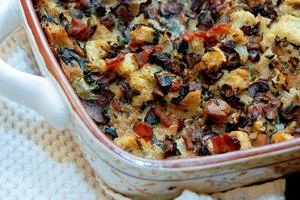 Colorful Mediterranean vegetable casserole with roasted eggplant peppers and herbs in glass baking dish