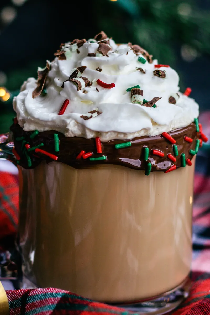 Close up view of boozy Christmas coffee with chocolate rim and mint shavings