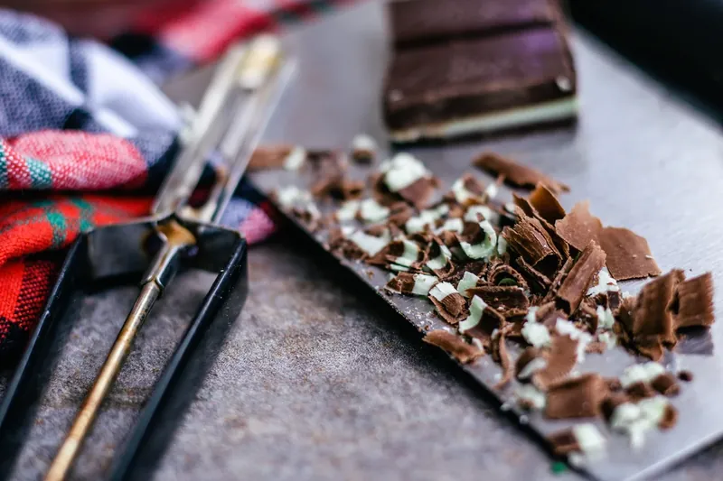 Andes mint chocolate being shaved for coffee garnish