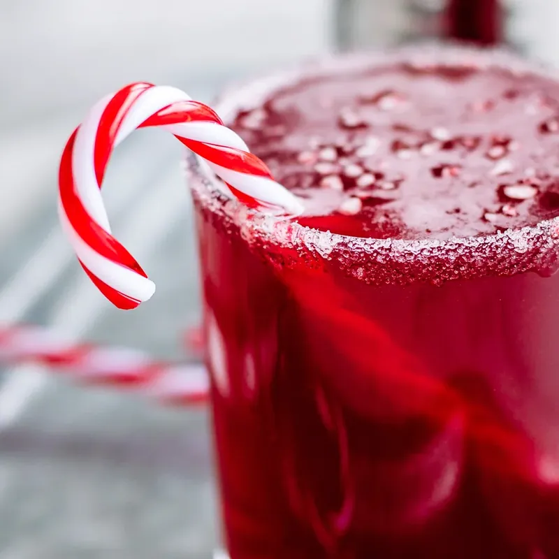 Candy cane margarita styled with holiday candy canes and festive decorations