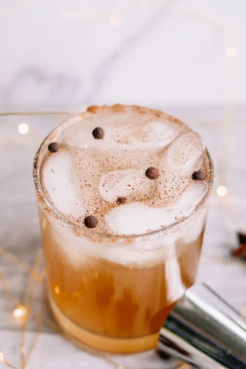 Close up of gingerbread margarita with detailed view of cinnamon sugar rim and nutmeg garnish