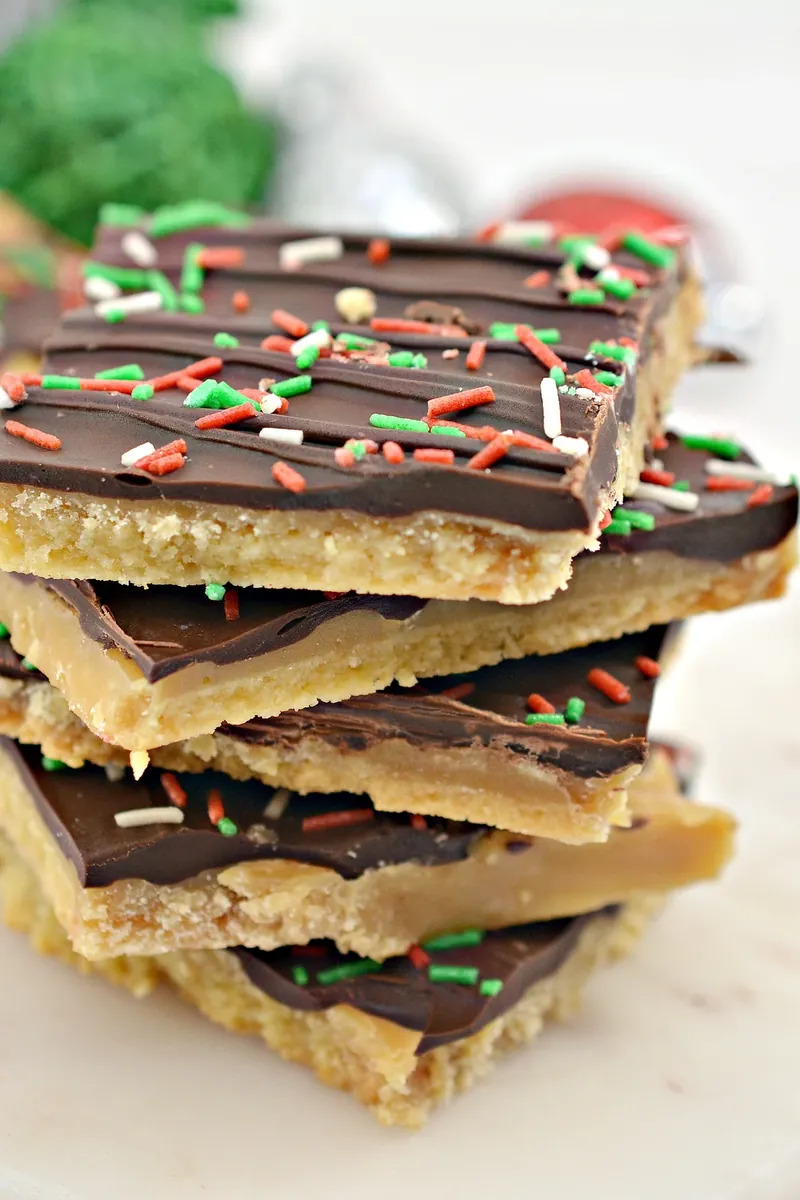 Final stack of keto Christmas crack bars with festive background