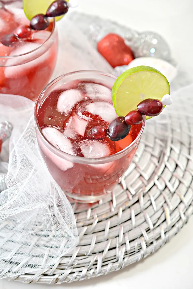 Elegantly presented keto Christmas margaritas with lime and cranberry garnish