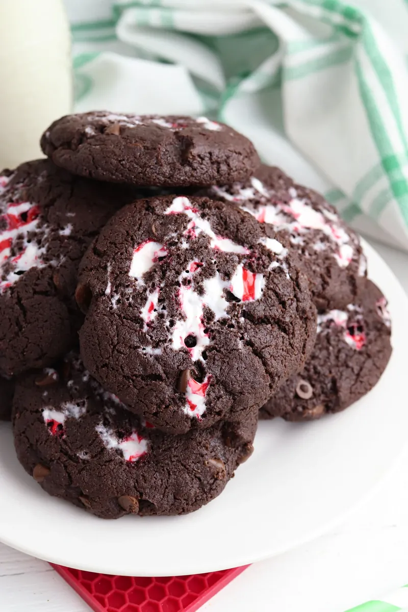 Stack of finished peppermint chocolate cake mix cookies with festive decorations
