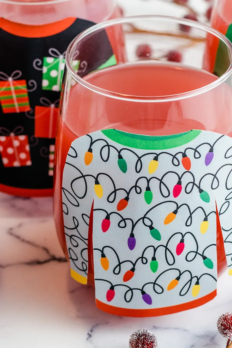 Close up view of Christmas light sweater glass filled with sparkling margarita punch