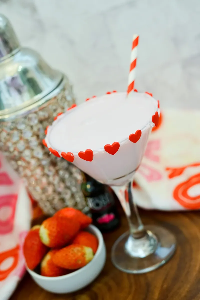 Finished Valentine's chocolate strawberry martini with heart rim decorations and cocktail shaker